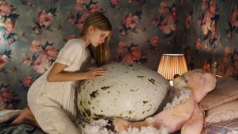 Twelve-year-old gymnast Tinja (Siiri Solalinna) hovers over her massive, monstrous egg in Hatching