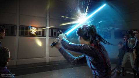 A woman deflects a blaster bolt with her lightsaber while other guests look on.
