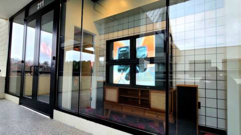 The storefront at Limited Run’s retail store includes a four-tv-screen grid display