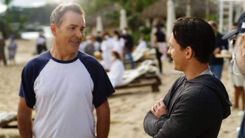 a photo of Nolan North looking at Tom Holland on the beach, on the set of the Uncharted movie