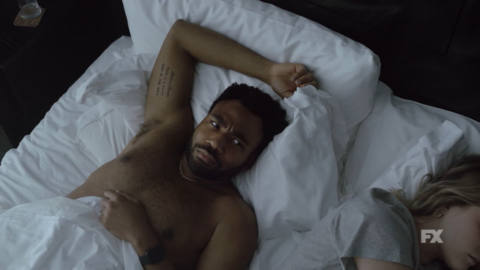 donald glover waking up in bed with a surprised look on his face in Atlanta season 3