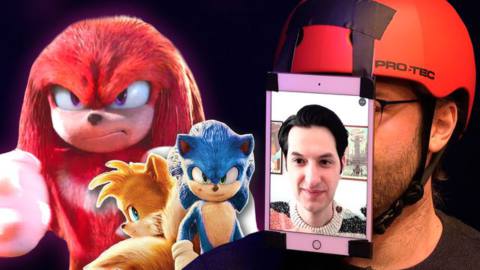 On the right, a man with an iPad taped to his face with an image of Sonic voice actor Ben Schwartz on it. On the left images of Sonic, Tales, and Knuckles from the Sonic the Headgehog 2 movie.