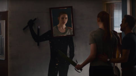 Karen Gillen getting ready to fight a dummy with a mirror on its head in Dual