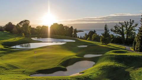 The sun setting over a golf green in EA Sports PGA Tour