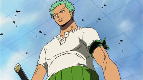 zoro from one piece stands as rubble blows around him.