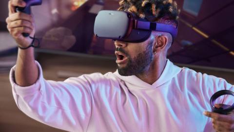 a man using Oculus Quest and a controller