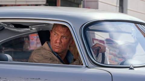 Daniel Craig looks beat to hell in a beat-to-hell care as James Bond in No Time To Die