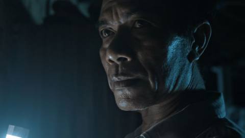 Yannawoutthi Chanthalungsy as the Old Man in The Long Walk, in close-up, looking grim