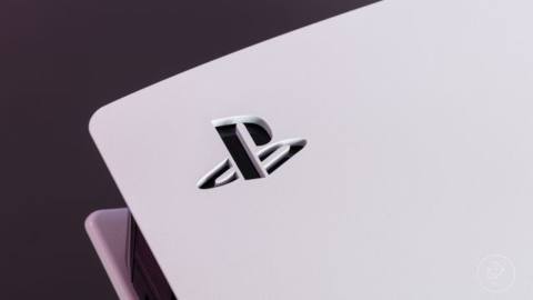 A close-up of the stenciled PlayStation logo on the white side panel of the PS5