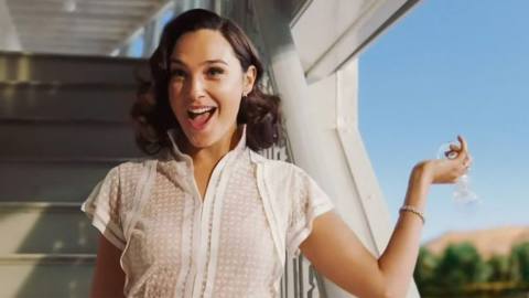 Gal Gadot tosses champagne over the side of the ship in Death on the Nile.
