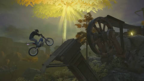 a person midair on a motobike with the erd tree in the background
