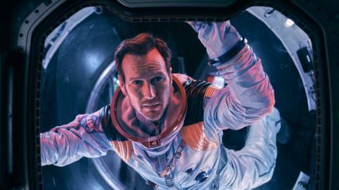Patrick Wilson in a spacesuit floats in an airlock in Moonfall