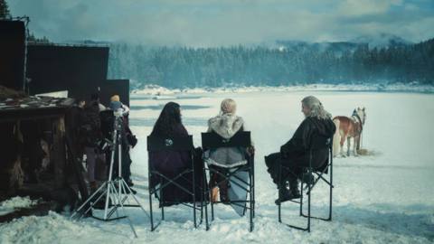 The Witcher’s cast, including Henry Cavill, Anya Chalotra, and Freya Allen, sit on the set of season 3