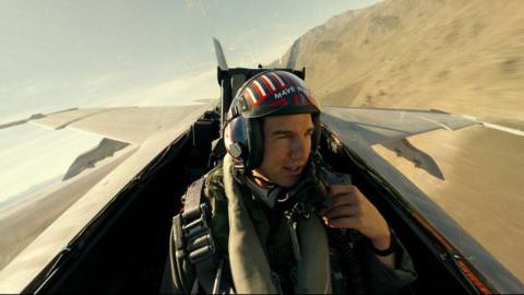 Tom Cruise removes his face mask in the cockpit of a fighter jet in Top Gun: Maverick
