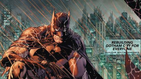 Batman crouches on a rainswept rooftop looking menacing. Behind him in the distance, rooftops bear a billboard that reads “Rebuilding Gotham City for Everyone: Wayne Enterprises,” in Batman #86 (2020).