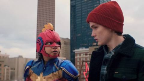 Ms. Marvel and her friend in a red beanie prepare to jump off a building