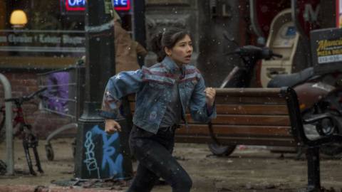 Xochitl Gomez as America Chavez runs through the street in Doctor Strange in the Multiverse of Madness.