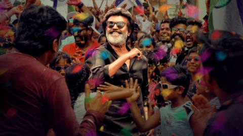 Rajinikanth with a colorful background of people in Kaala.