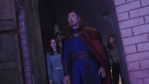 Rachel McAdams as Dr. Christine Palmer, Benedict Cumberbatch as Dr. Stephen Strange, and Xochitl Gomez as America Chavez stand in a brick doorway in Doctor Strange and the Multiverse of Madness.