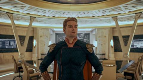 Homelander stands in the Seven’s meeting room in a hero pose in season 3 of The Boys.