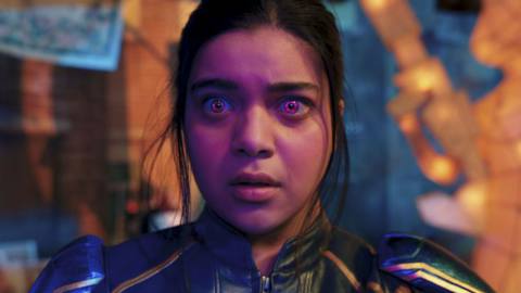 Iman Vellani as Kamala Khan, with glowing purple eyes against a neon background