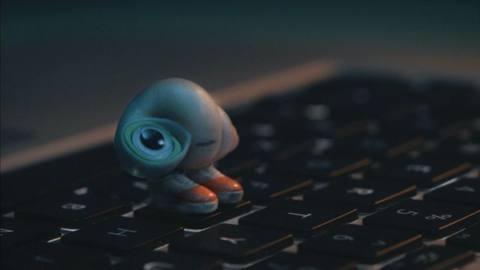 Marcel the Shell, a tiny shell voiced by Jenny Slate, stands on a keyboard in the film Marcel the Shell With Shoes On