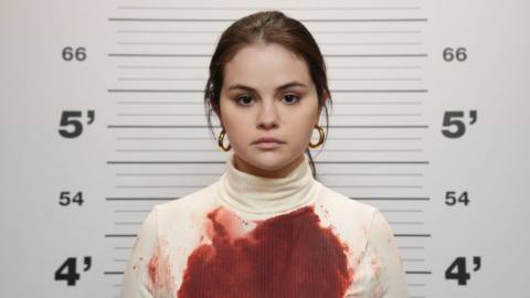 Selena Gomez gets her mugshot taken in a blood-soaked sweater in Only Murders in the Building season 2