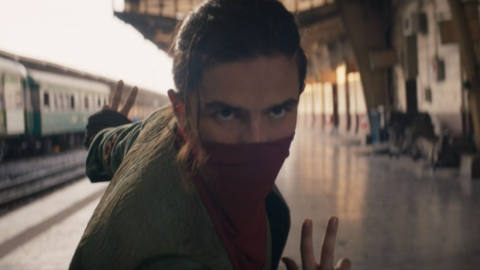 Aramis Knight poses dramatically with a red bandana covering his nose and mouth as the Red Dagger in Ms. Marvel. 