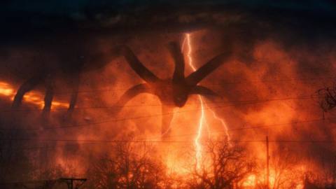The Mind Flayer looms over the landscape in Stranger Things