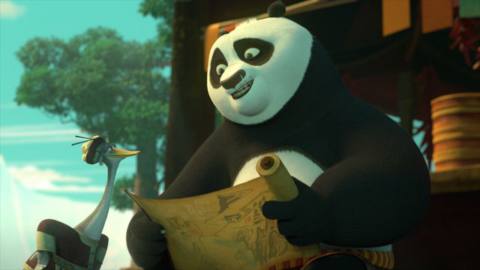 po the panda looking at a scroll 