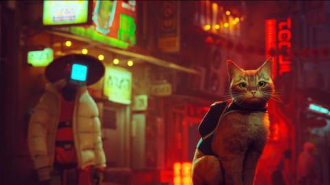 The unnamed orange cat of Stray sits, wearing a backpack, with a humanoid robot and a neon-lit city behind it