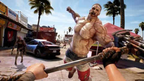 A first-person view of a huge zombie unleashing a punch, while the hero readies a hammer, on a Venice Beach street