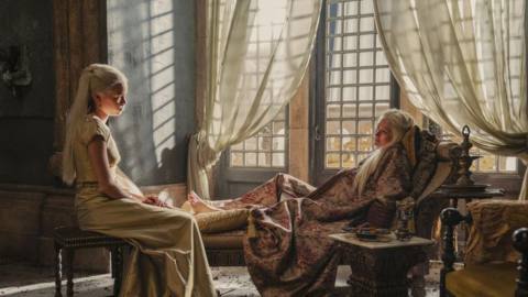 Rhaenyra Targaryen sitting and talking to her mother, who is reclining and very pregnant