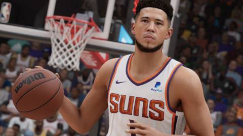 waist-up closeup of Phoenix’s Devin Booker bringing the basketball up the court