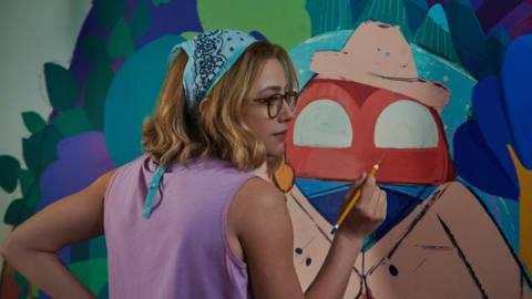 Natalie (Lili Reinhart) paints a colorful wall mural in Look Both Ways. 