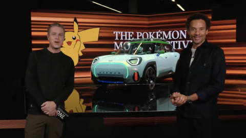 a still of Oliver Heilmer, head of&nbsp;Mini&nbsp;Design, and Geoff Keighly standing in front of the Aceman Mini x Pokémon collab hatchback at Gamescom