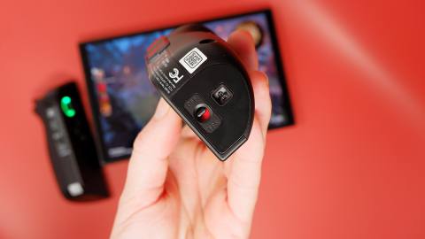 The Lenovo Legion Go on a red background with FPS mode on show on one controller.
