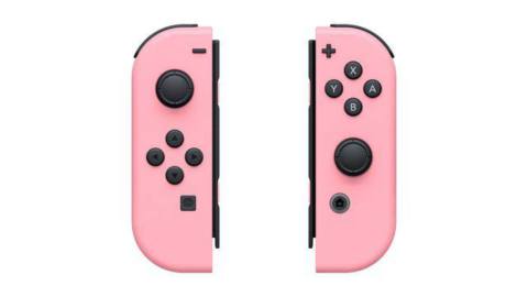 A photo of two Nintendo Switch Joy-Con controllers in pastel pink color.