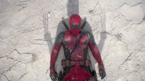 Ryan Reynolds as Deadpool laying on the ground with Wolverine’s shadow above him in Deadpool &amp; Wolverine