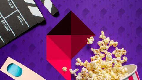 A popcorn bucket next to a film clapper, 3D glasses, and the Polygon logo set against a purple background.
