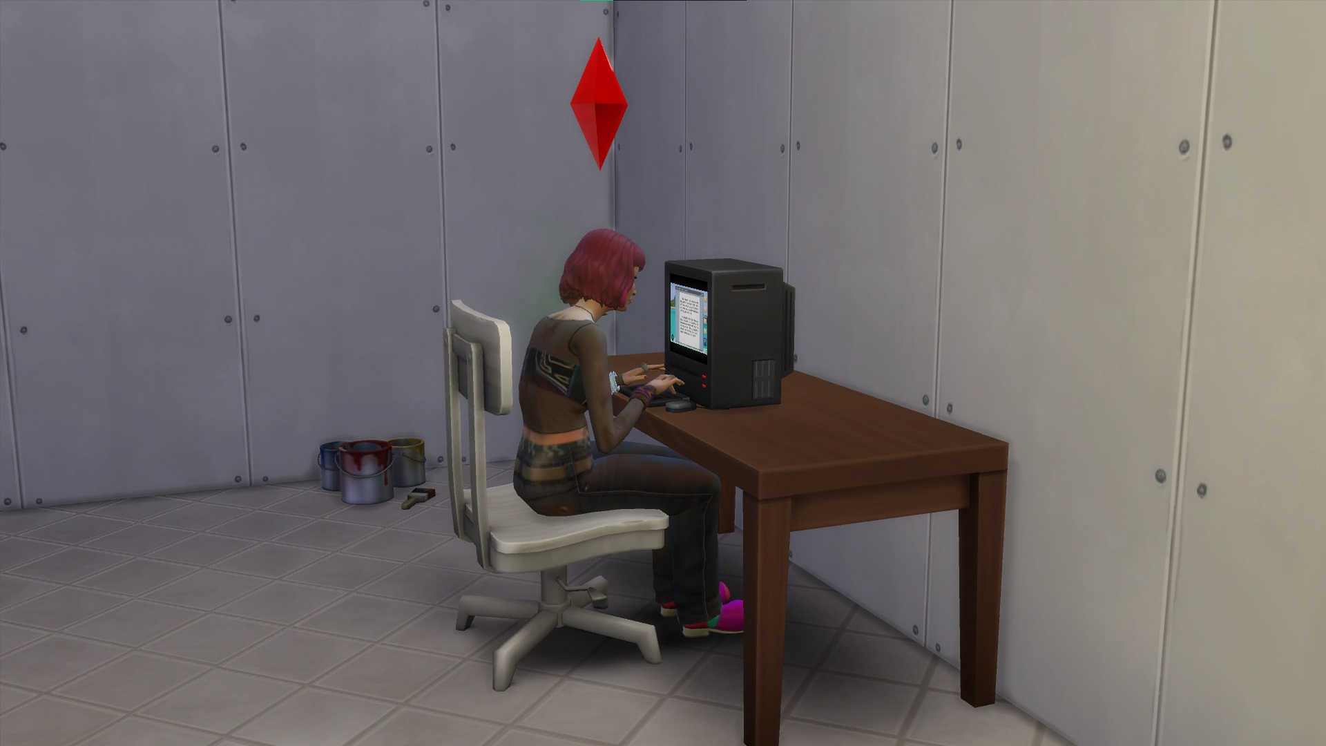 The Sims 4 - a pink haired sim sits at an old computer in an undecorated room