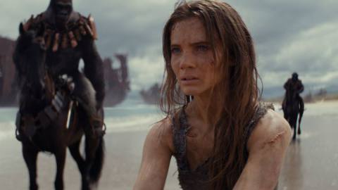 Freya Allan as Mae, a human being flanked by apes on horseback, in a still from Kingdom of the Planet of the Apes