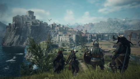 An adventuring party looks across fields at the town of Vernwerth in Dragon’s Dogma 2