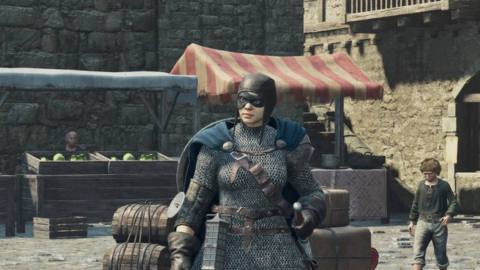 A Fighter stands in the center of the Vernmouth town square in Dragon’s Dogma 2.