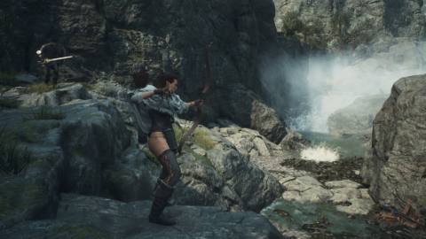 An archer Arisen standing atop a rocky outcrop in Dragon's Dogma 2.