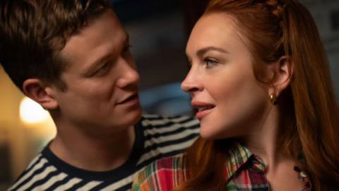 Ed Speelers shows Lindsey Lohan how to play darts. The two look longingly into each other’s eyes