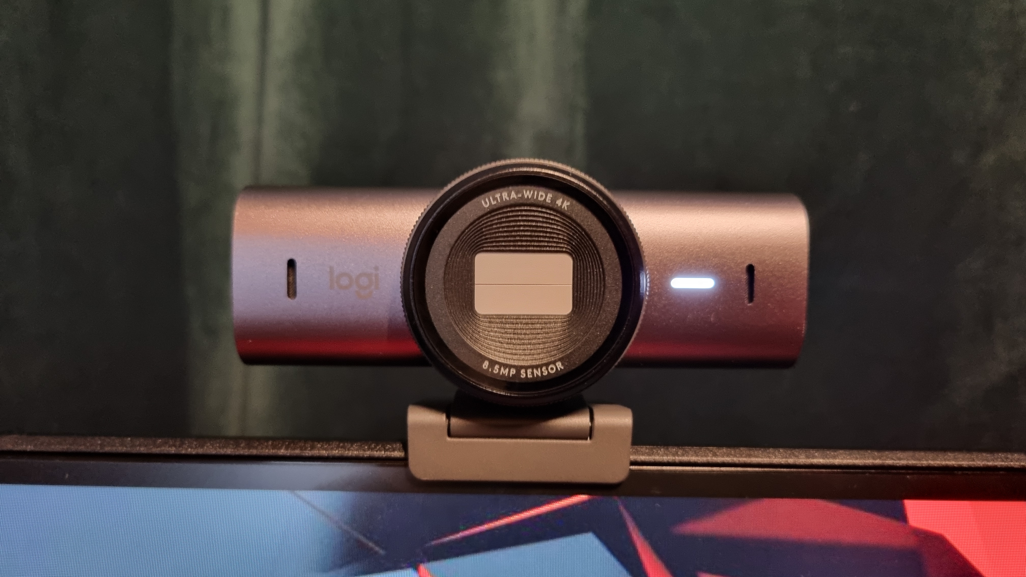 The Logitech MX Brio with privacy cover closed, on top of a monitor