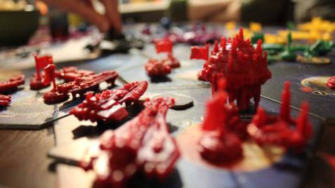 Red ships on the board for a game of Twilight Imperium.