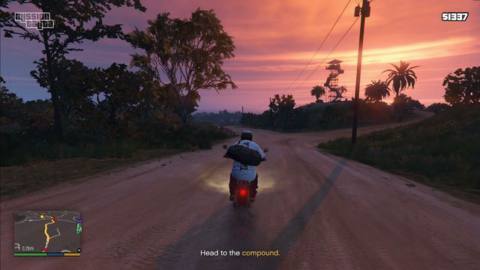 A player in the Mission Talita mod rides a dirt bike down Cayo Perico. They are engaged in a mission to find kidnapped women in the island’s compound.