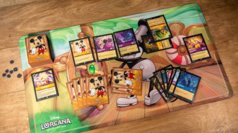 A layout for a single player in Disney Lorcana. The action moves clockwise from the upper left, and includes cards currently played an those waiting to be played. There’s also a pool of ink and the player’s hand, which is normally kept private.